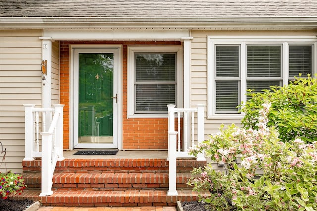 924 Violet Ave, Hyde Park, NY 12538 - doorway to property featuring roof with shingles and brick siding