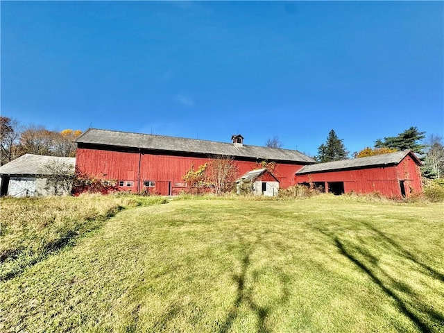 255 Howells Rd, Middletown, NY 10940 - rear view of house with a barn, a lawn, and an outbuilding