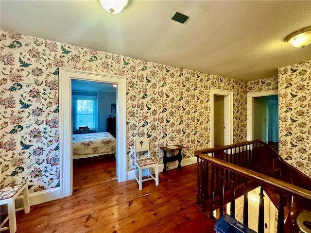 255 Howells Rd, Middletown, NY 10940 - hallway with wood finished floors, baseboards, wallpapered walls, and an upstairs landing