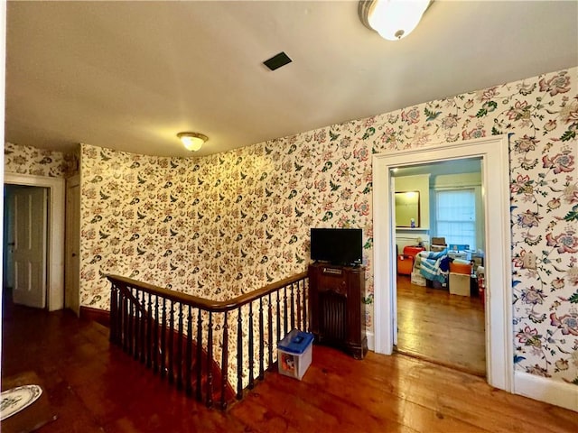 255 Howells Rd, Middletown, NY 10940 - corridor featuring wallpapered walls, hardwood / wood-style floors, an upstairs landing, and baseboards