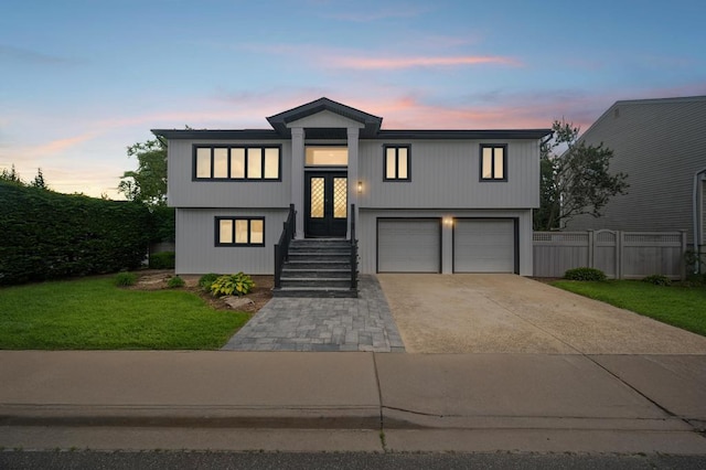 1 Saratoga St, Lido Beach, NY 11561 - view of front facade featuring concrete driveway and an attached garage