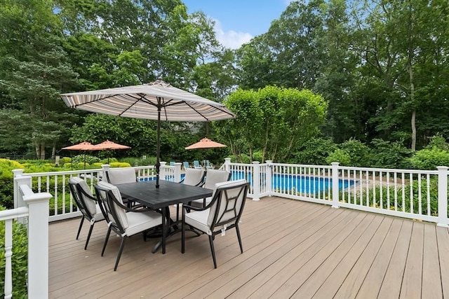 6295 N Country Rd, Wading River, NY 11792 - deck with an outdoor pool, outdoor dining space, and view of scattered trees