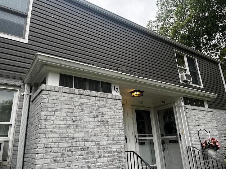 10 Glen Keith Rd Unit U, Glen Cove, NY 11542 - view of home's exterior with brick siding