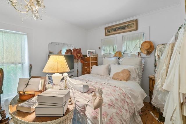 83 Tennanah Lake Rd, Roscoe, NY 12776 - bedroom with multiple windows, crown molding, a chandelier, and hardwood / wood-style floors