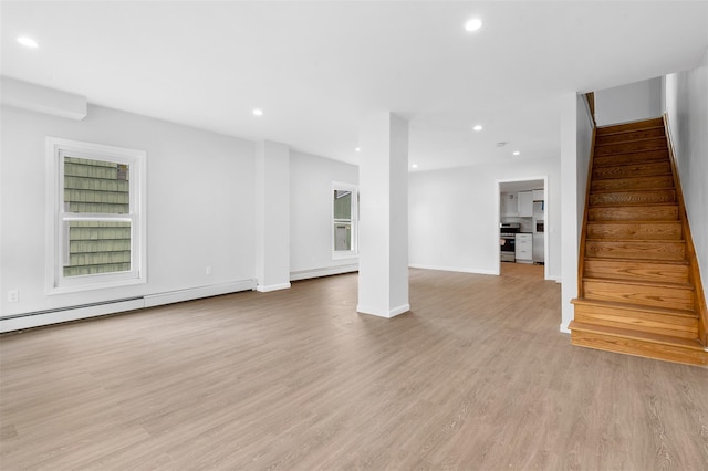 8 Chestnut St, Middletown, NY 10940 - unfurnished living room featuring a baseboard heating unit, stairs, recessed lighting, light wood-style floors, and baseboards
