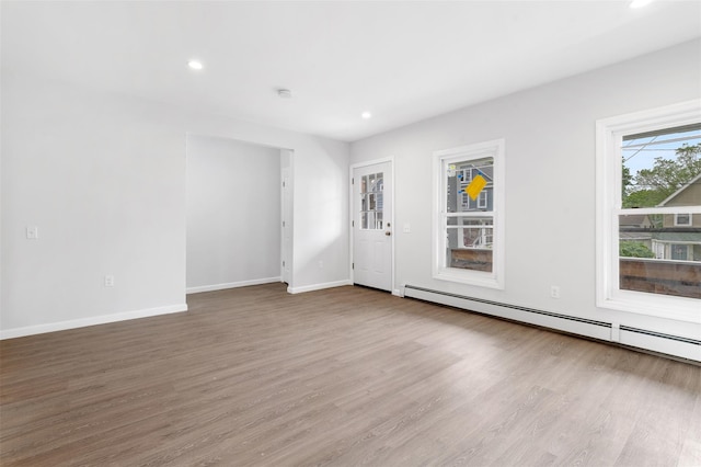 8 Chestnut St, Middletown, NY 10940 - unfurnished room with a baseboard heating unit, wood finished floors, recessed lighting, baseboards, and a smoke detector