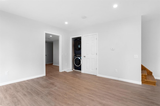 8 Chestnut St, Middletown, NY 10940 - unfurnished living room featuring stacked washer and clothes dryer, baseboards, wood finished floors, and recessed lighting