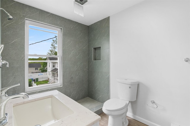 8 Chestnut St, Middletown, NY 10940 - bathroom with toilet, vanity, a tile shower, and wood finished floors