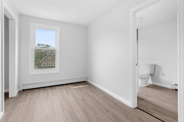 8 Chestnut St, Middletown, NY 10940 - unfurnished bedroom with baseboard heating, wood finished floors, and baseboards
