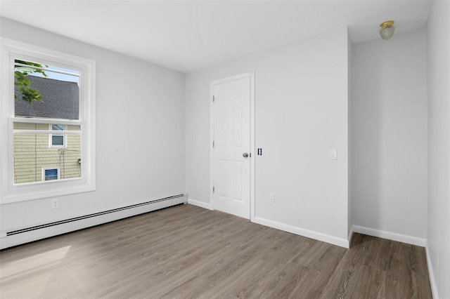 8 Chestnut St, Middletown, NY 10940 - spare room with wood finished floors, a baseboard radiator, and baseboards