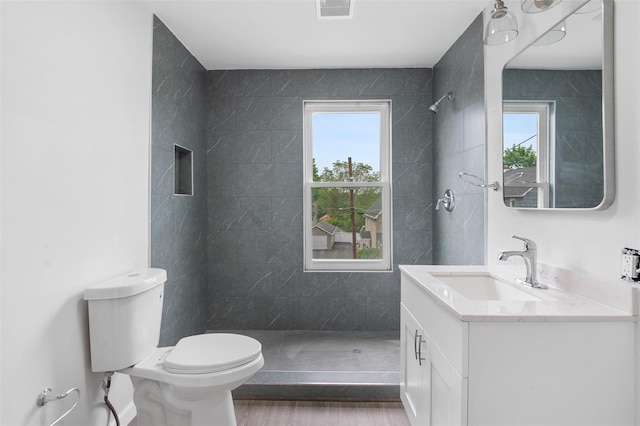 8 Chestnut St, Middletown, NY 10940 - bathroom with toilet, vanity, tiled shower, and wood finished floors