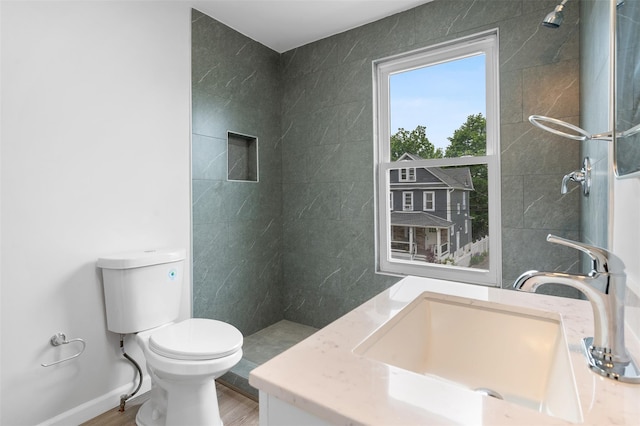 8 Chestnut St, Middletown, NY 10940 - bathroom with toilet, vanity, wood finished floors, baseboards, and tiled shower