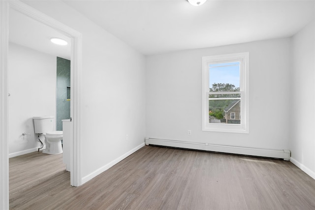 8 Chestnut St, Middletown, NY 10940 - unfurnished bedroom with wood finished floors, a baseboard heating unit, and baseboards