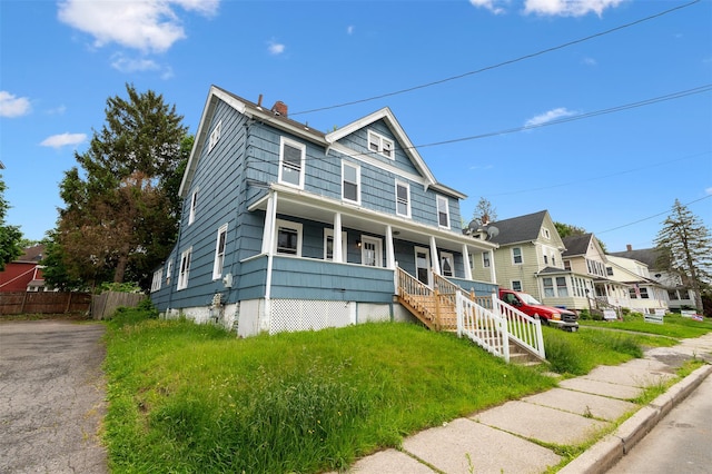 8 Chestnut St, Middletown, NY 10940 - view of front facade featuring a porch, a chimney, and a residential view