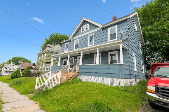 8 Chestnut St, Middletown, NY 10940 - american foursquare style home with covered porch, a chimney, and a front yard