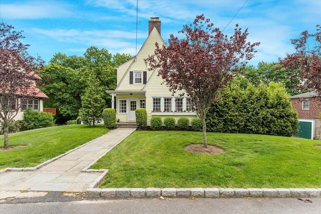 21 Chester Pl, New Rochelle, NY 10801 - view of front of home with a front lawn and a chimney