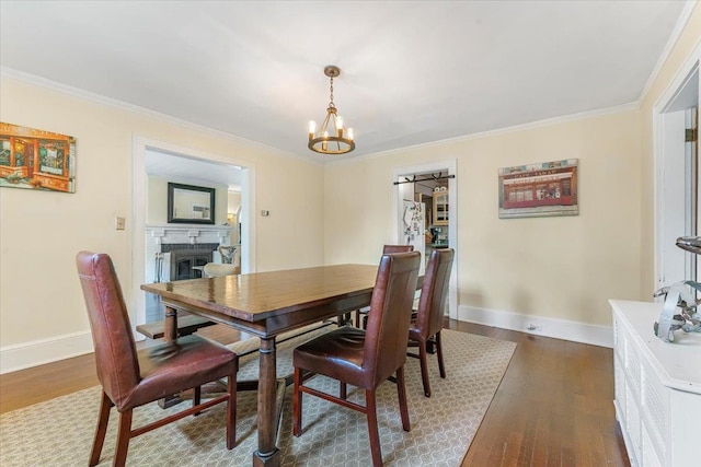 21 Chester Pl, New Rochelle, NY 10801 - dining area with a fireplace, dark wood-type flooring, baseboards, and crown molding