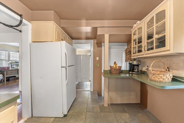 21 Chester Pl, New Rochelle, NY 10801 - kitchen with freestanding refrigerator, decorative backsplash, glass insert cabinets, and cream cabinets