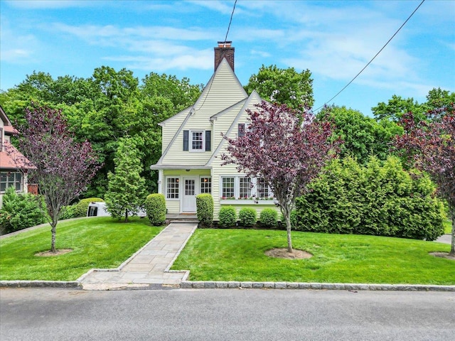 21 Chester Pl, New Rochelle, NY 10801 - view of front facade with a chimney and a front yard