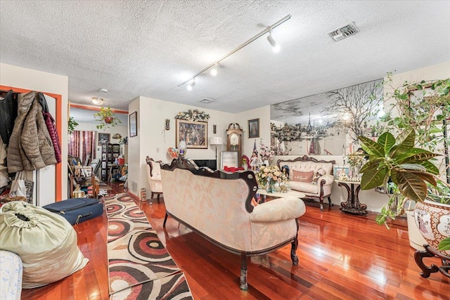 977 E 179th St, Bronx, NY 10460 - living area featuring hardwood / wood-style floors, a textured ceiling, and rail lighting