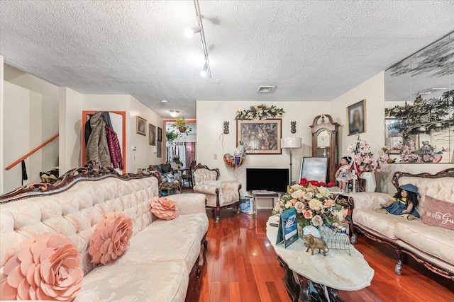 977 E 179th St, Bronx, NY 10460 - living area with wood finished floors, a textured ceiling, and track lighting