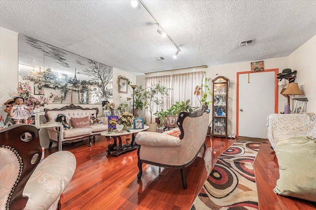977 E 179th St, Bronx, NY 10460 - living room with a textured ceiling, wood-type flooring, and track lighting