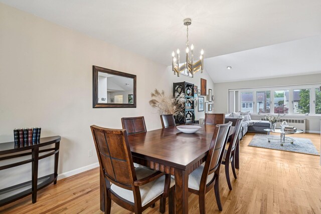 904 Woodmere Dr, North Woodmere, NY 11581 - dining room featuring a chandelier, lofted ceiling, light wood-style floors, baseboards, and radiator