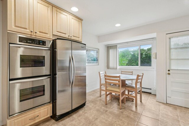 904 Woodmere Dr, North Woodmere, NY 11581 - kitchen featuring stainless steel appliances, light brown cabinets, recessed lighting, a baseboard heating unit, and light tile patterned floors