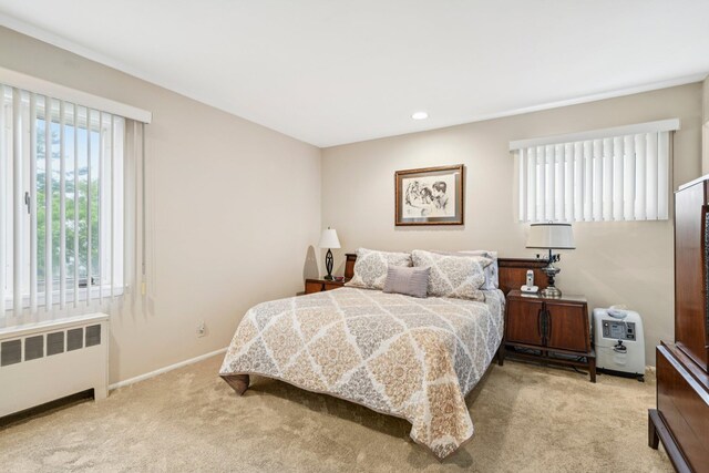 904 Woodmere Dr, North Woodmere, NY 11581 - bedroom with radiator, light colored carpet, baseboards, and recessed lighting