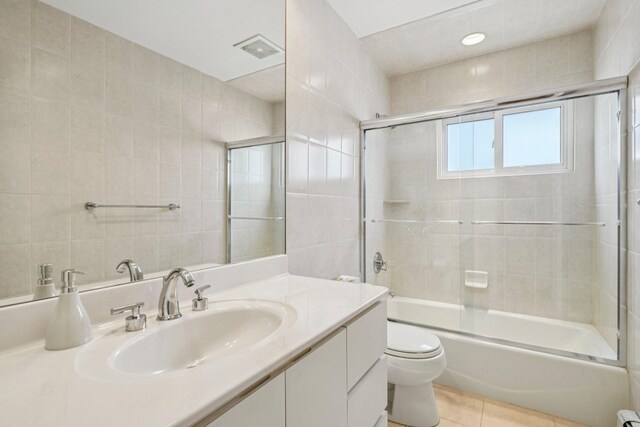 904 Woodmere Dr, North Woodmere, NY 11581 - bathroom with toilet, vanity, enclosed tub / shower combo, and tile patterned flooring