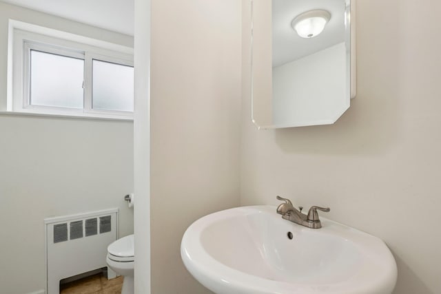 904 Woodmere Dr, North Woodmere, NY 11581 - bathroom with radiator, a sink, and toilet