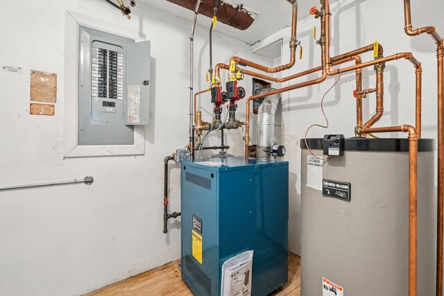 904 Woodmere Dr, North Woodmere, NY 11581 - utility room with gas water heater, electric panel, and a heating unit