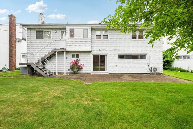 904 Woodmere Dr, North Woodmere, NY 11581 - rear view of property featuring a yard, a cooling unit, a chimney, and a patio area
