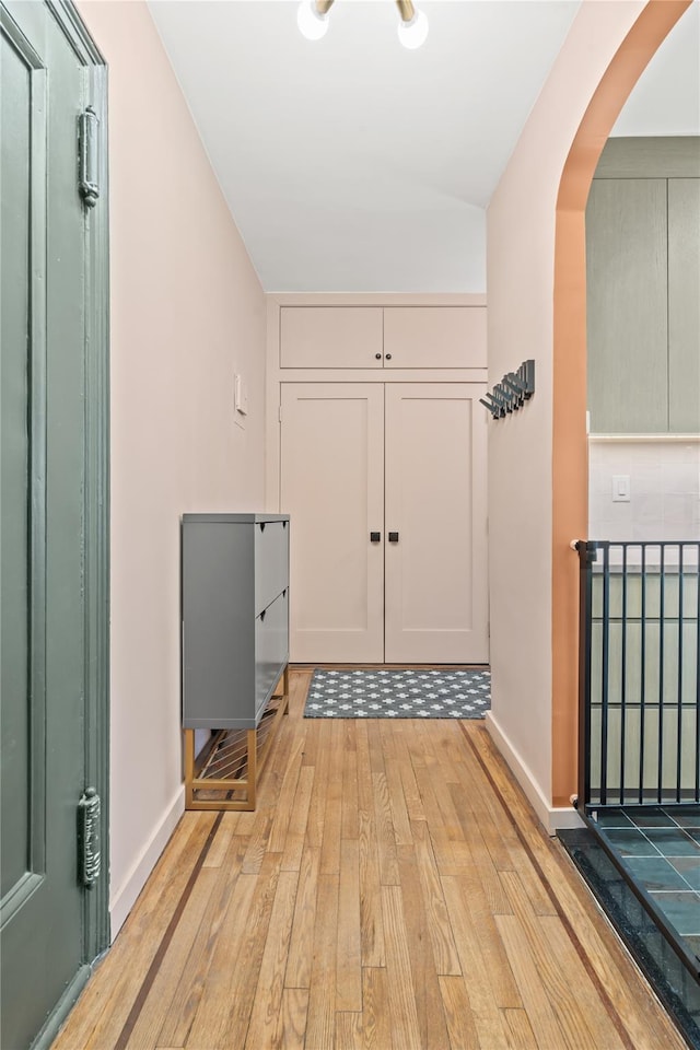 73-20 Austin St Unit 6K, Forest Hills, NY 11375 - entryway featuring light wood-style floors, arched walkways, baseboards, and lofted ceiling