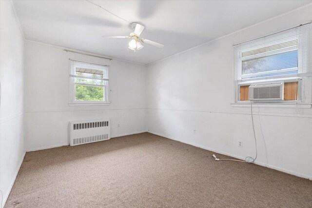 18 Overlook Ln, Plainview, NY 11803 - unfurnished room with radiator heating unit, carpet flooring, a ceiling fan, baseboards, and crown molding