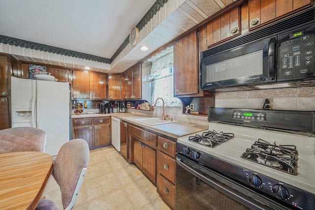 47-04 167th St, Flushing, NY 11358 - kitchen with gas stove, black microwave, a sink, white refrigerator with ice dispenser, and light countertops