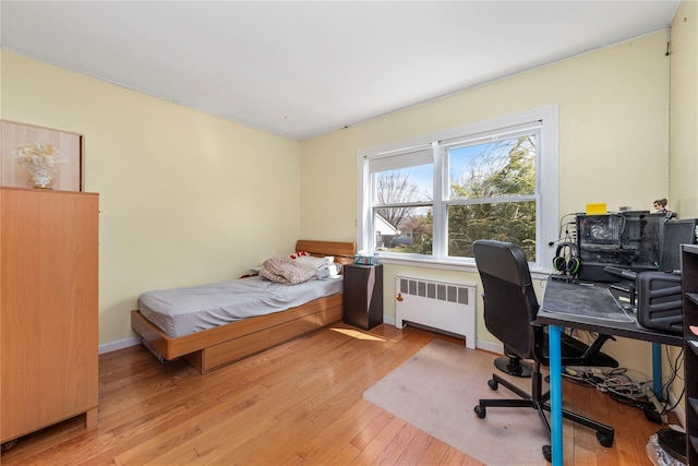 30 Eaton Rd, Syosset, NY 11791 - bedroom with radiator heating unit, light wood finished floors, an office area, and baseboards