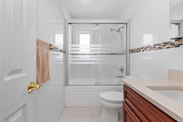 30 Eaton Rd, Syosset, NY 11791 - bathroom with vanity, combined bath / shower with glass door, tile patterned flooring, toilet, and tile walls