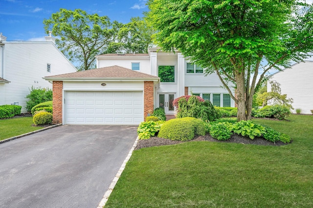 120 Fairway View Dr Unit 120, Commack, NY 11725 - view of front of home featuring asphalt driveway, brick siding, an attached garage, a front lawn, and roof with shingles