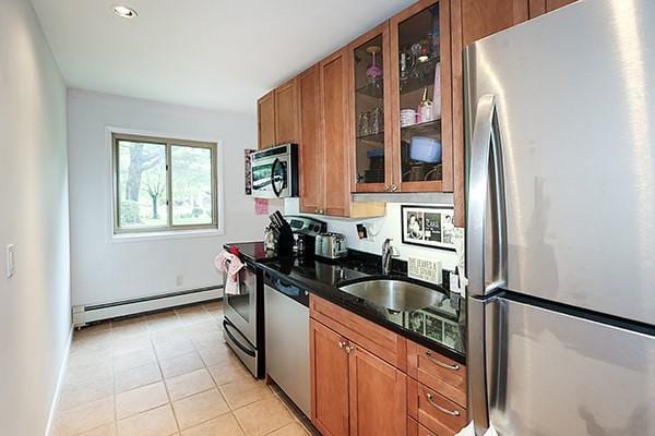 2449 Union Blvd Unit 24A, Islip, NY 11751 - kitchen featuring stainless steel appliances, a baseboard radiator, brown cabinets, a sink, and light tile patterned floors