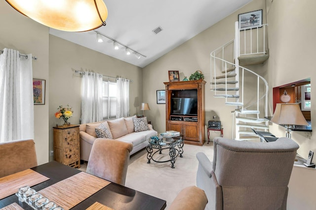 1425 Jerusalem Ave Unit 19, North Merrick, NY 11566 - living room with rail lighting, lofted ceiling, stairway, and light colored carpet