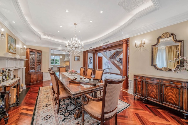 184-61 Radnor Rd, Jamaica Estates, NY 11432 - dining space featuring a chandelier, a tray ceiling, crown molding, a wainscoted wall, and decorative columns