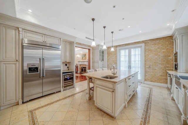 184-61 Radnor Rd, Jamaica Estates, NY 11432 - kitchen with built in refrigerator, beverage cooler, cream cabinets, inlaid floor details, and a sink