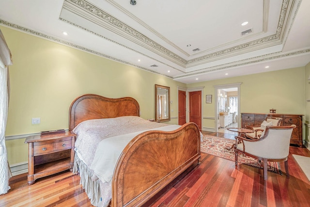 184-61 Radnor Rd, Jamaica Estates, NY 11432 - bedroom featuring wood finished floors, ornamental molding, a raised ceiling, ensuite bathroom, and baseboards