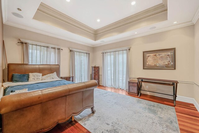 184-61 Radnor Rd, Jamaica Estates, NY 11432 - bedroom featuring a tray ceiling, wood finished floors, ornamental molding, recessed lighting, and baseboards