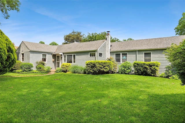 40 Maidstone Ave, East Hampton, NY 11937 - single story home with a front lawn, a chimney, and roof with shingles