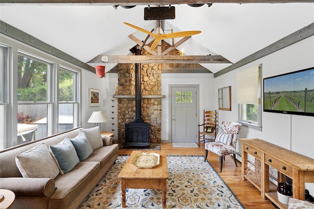40 Maidstone Ave, East Hampton, NY 11937 - living area featuring a wood stove, beamed ceiling, light wood-type flooring, and high vaulted ceiling
