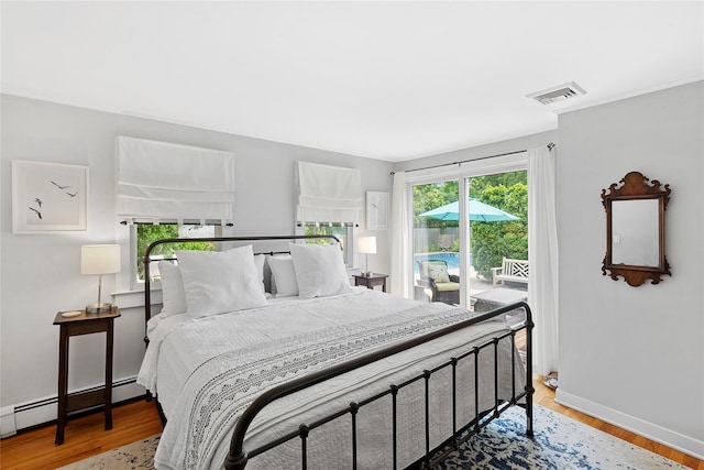 40 Maidstone Ave, East Hampton, NY 11937 - bedroom with access to outside, light wood finished floors, baseboards, and a baseboard radiator