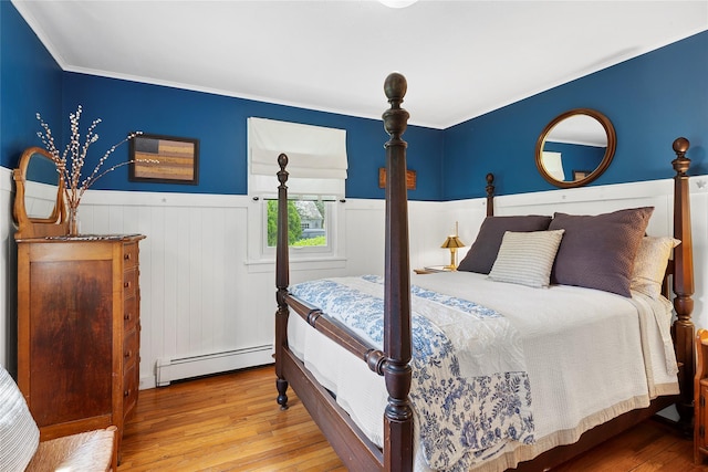 40 Maidstone Ave, East Hampton, NY 11937 - bedroom with a baseboard radiator, wainscoting, hardwood / wood-style flooring, and ornamental molding