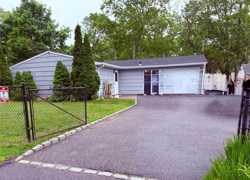 2 Pinetop Dr, Shirley, NY 11967 - view of front facade with driveway, an attached garage, and a gate